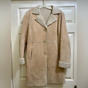 Long suede, button down coat with furry interior lining.